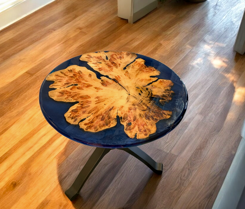 Unique table with top made of Boxelder burl wood inlaid in custom colored blue epoxy with black pedestal base.