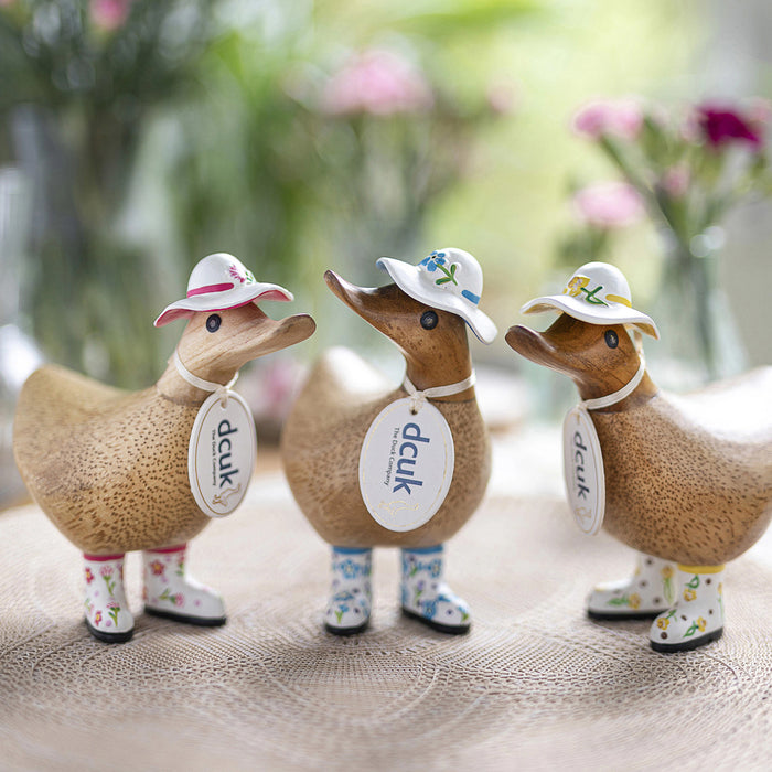 DCUK wooden duck with daffodil flower hat and matching boots, handmade wooden gift featuring a charming duckling design.