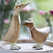 Handmade DCUK wood duckling with daffodil flower hat and matching wooden boots, showcasing charming handcrafted wooden gifts.