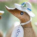 Handmade DCUK wood duck with a forget-me-not flower hat and boots, showcasing detailed wooden craftsmanship.