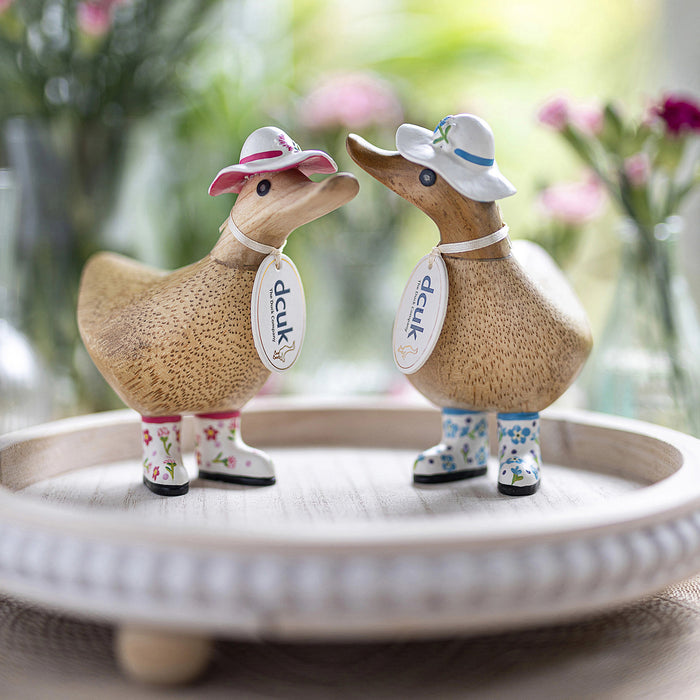 DCUK wooden duck figurine with a forget-me-not flower hat and matching boots, handcrafted wooden gift from DCUK Wood Ducks collection.