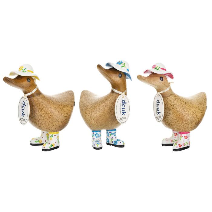 DCUK wood duck figurine with forget-me-not flower hat and matching boots, handmade wooden gift, detailed and charming decorative piece.