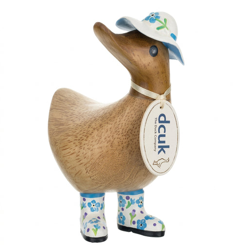Handmade DCUK wooden duck wearing a forget-me-not flower hat and boots, part of DCUK's wooden duck gift collection.