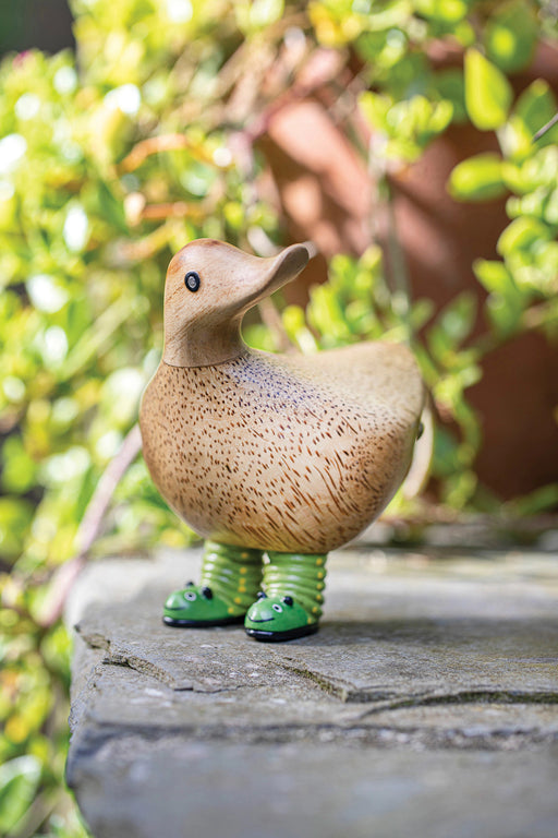 DCUK duck figurine featuring green caterpillar boots