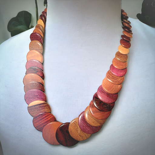 Handmade necklace with overlapping discs of exotic woods, showcasing Purple Heart, Pau Amarillo, and Cocobolo tones.