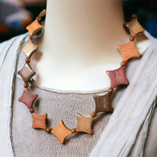 Elegant diamond cut wood necklace on display, featuring assorted woods like purple heart, cocobola, and pau amarillo with intricate bead accents.