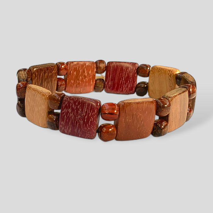 Wood stretch bracelet with square tiles and tiny beads, handcrafted from exotic woods, featuring a pattern of natural colors.