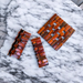 Cocobola folding wooden trivet on kitchen countertop.
