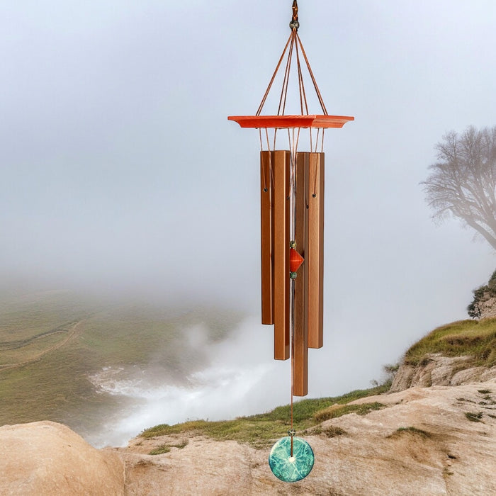 Woodstock Turquoise Wind Chime with cherry ash wood and bronze tubes set against a misty landscape, tuned in the key of G.