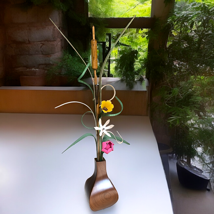 Handcrafted wooden flowers arranged in a sleek walnut vase on a table, inspired by Minnesota wildflowers, adding natural charm.