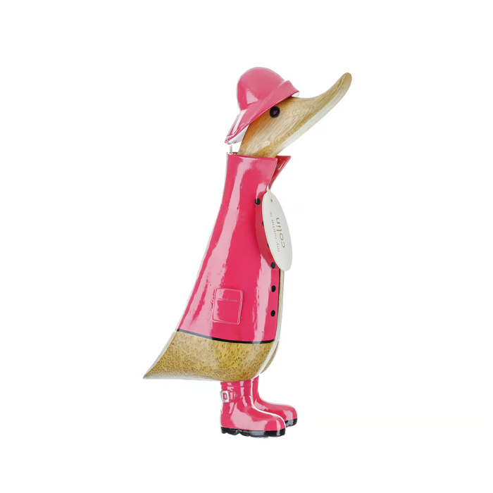 Wooden duckling wearing a vibrant pink raincoat and boots, crafted from sustainable bamboo wood.