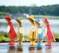 A group of bamboo root ducklings sporting bright colored  raincoats or rain gear