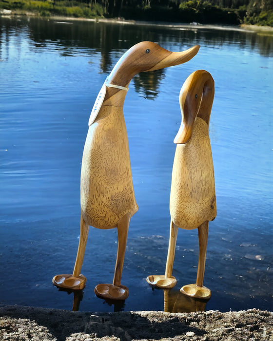 Bamboo root life-size wooden ducks by the lake, whimsical and sustainable decor perfect for homes or gifts.