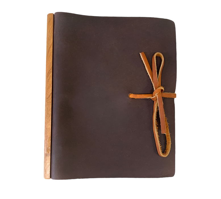 This Large Tie Leather Journal with Ring Binder unites modernity and rusticity with practicality. Meticulously handcrafted from full grain leather that is softened and textured, and augmented with a wooden band along the binding, the journal promotes an opulent writing or note-taking affair. The ring binder's robustness ensures that your notes and works remain securely stored. An exquisite and perpetual piece fit for any connoisseur. 