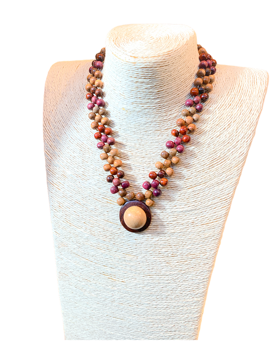 Beaded Diana Necklace in Exotic Woods with intricate details and unique hat pendant displayed on a mannequin