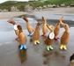 Handcrafted bamboo and teak wood ducklings with spotty boots on a beach, perfect for home decor or gifting