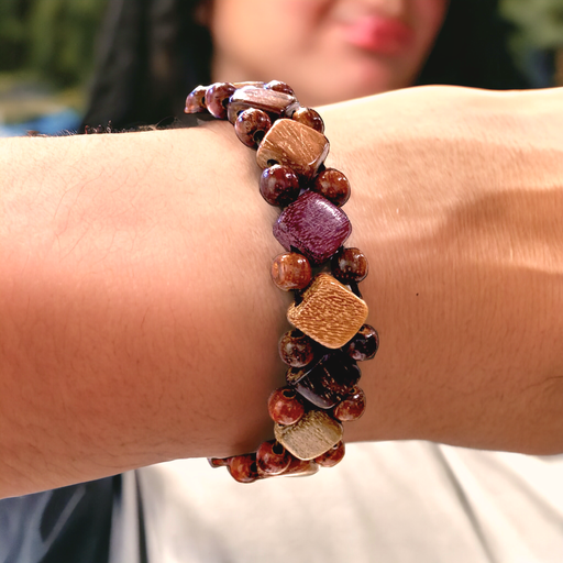 Exotic wood diamond and bead stretch bracelet on wrist showcasing natural hues and chic design.