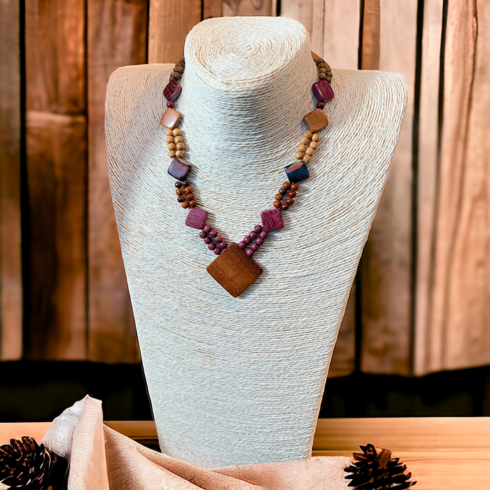 Wood Diamond Pendant Necklace with assorted Central American woods on display mannequin, featuring purple heart and cocobola beads.