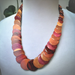 Handmade necklace with overlapping discs of exotic woods, showcasing Purple Heart, Pau Amarillo, and Cocobolo tones.