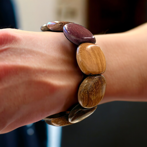 Exotic wood bracelet with rounded beads, featuring natural warm colors and a durable stretch cord for versatile wear.