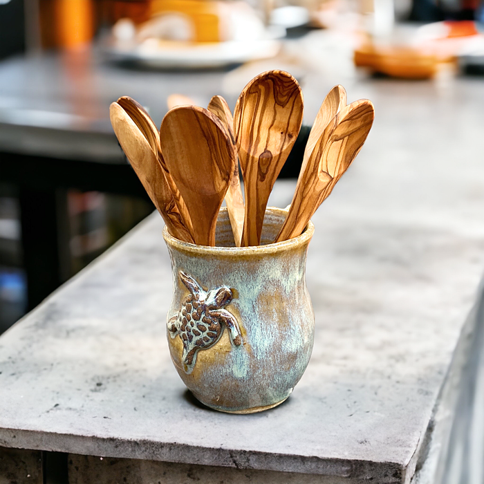 8-inch olive wood spoons displayed in a coffee mug made by potter, Mark Koepnick.