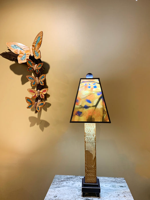 A Lamp with handmade glass and ceramic base with hand painted with yellow shade.