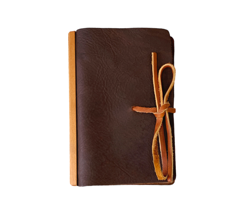 Handcrafted Full Grain Leather Journal. Enhanced by a unique Wood Accent running the spine's length, a Ring Binder for practicality, and a Leather Tie for secure closure, this journal is your canvas for creativity.